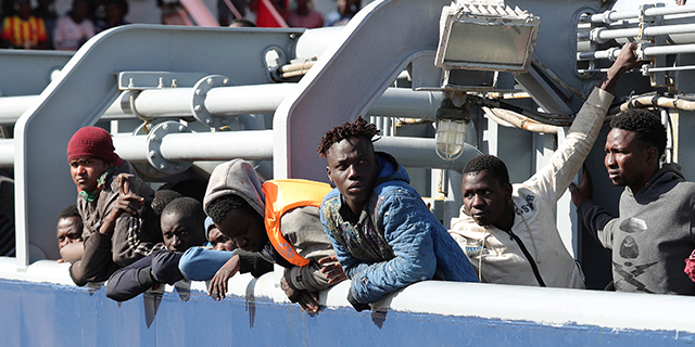Migrants rescued off the coast of Libya wait to disembark from the supply vessel OOC Panther in the Sicilian port of Messina, Italy, in April 2017. (Sipa via AP)
